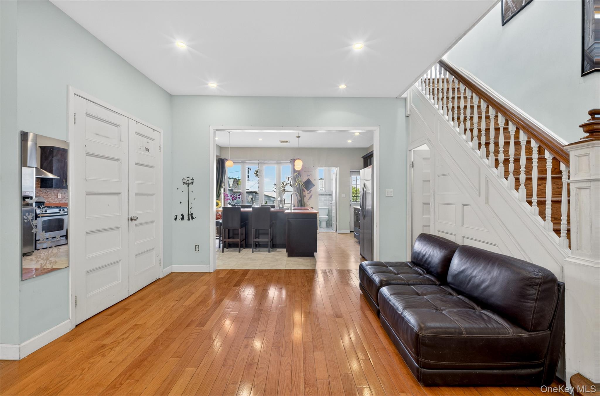 88-42 87th Street Queens, NY 11421 - Photo 6 of 33 a living room with furniture and wooden floor