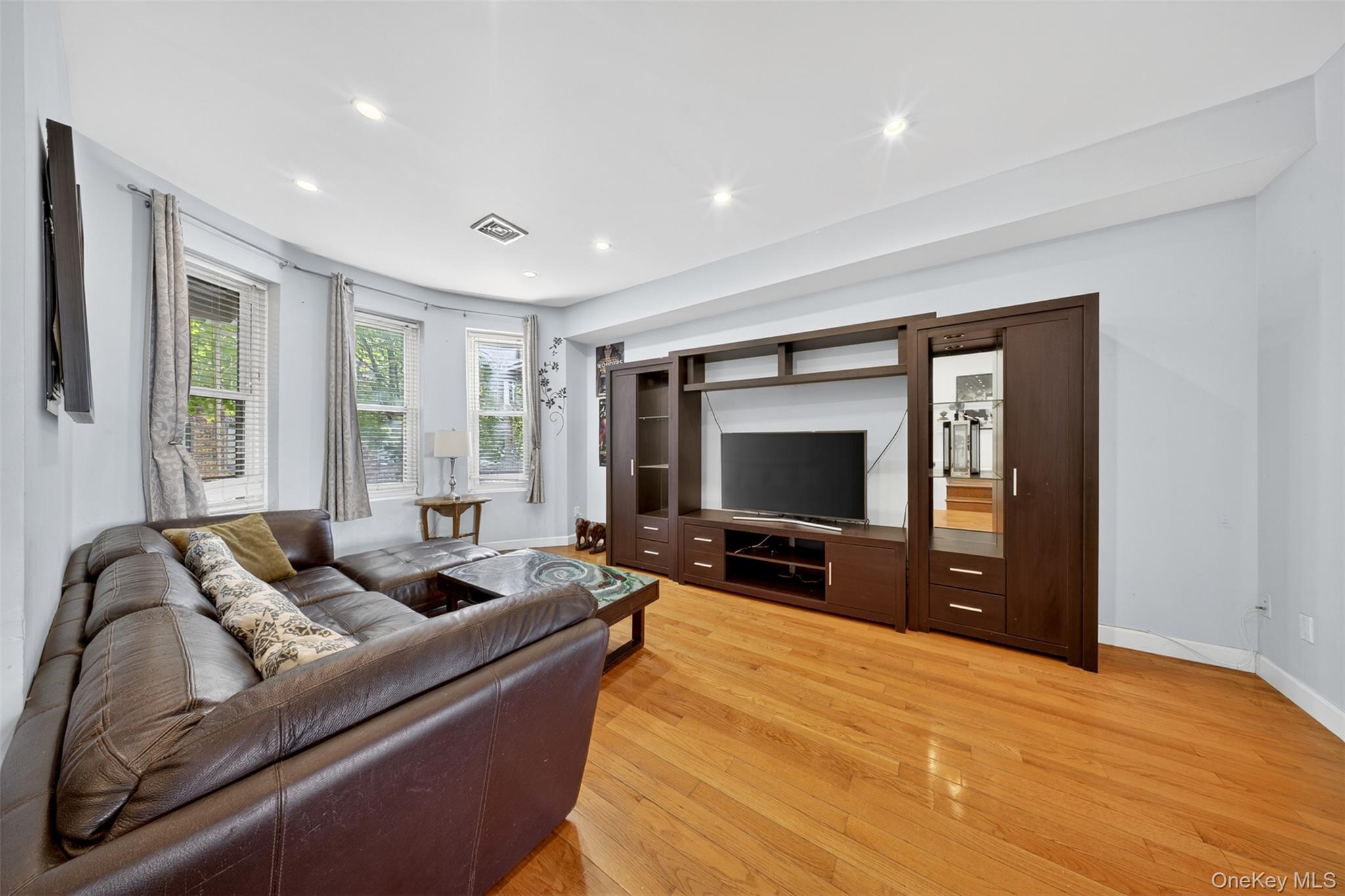 88-42 87th Street Queens, NY 11421 - Photo 7 of 33 a living room with furniture and a flat screen tv