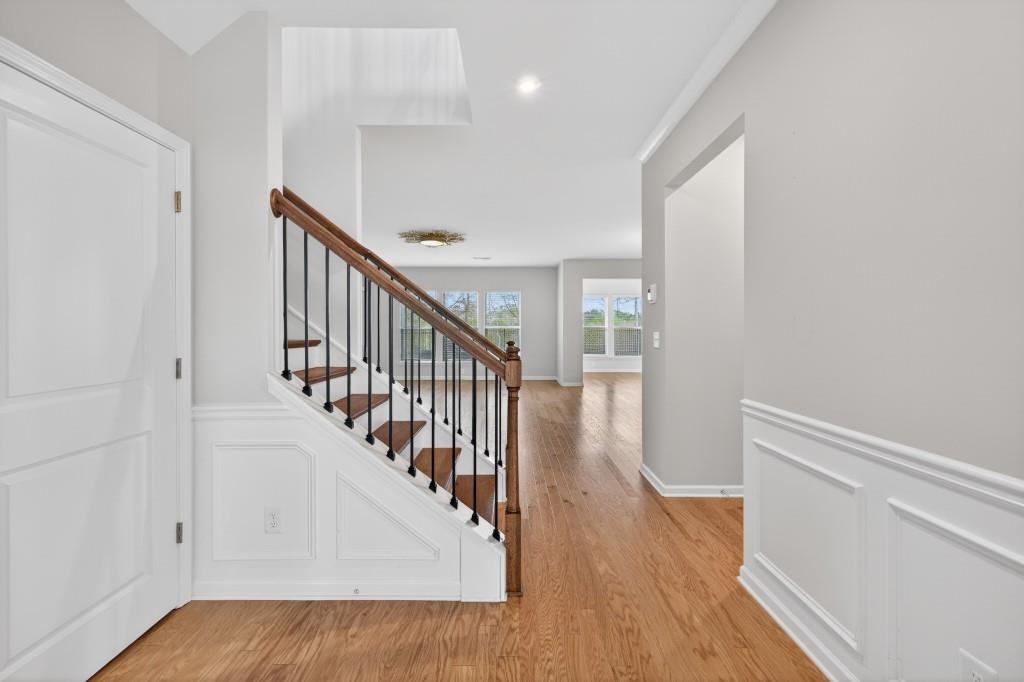 7277 Maple Brook Lane Flowery Branch, GA 30542 - Photo 11 of 57 a view of a hallway with wooden floor and entryway