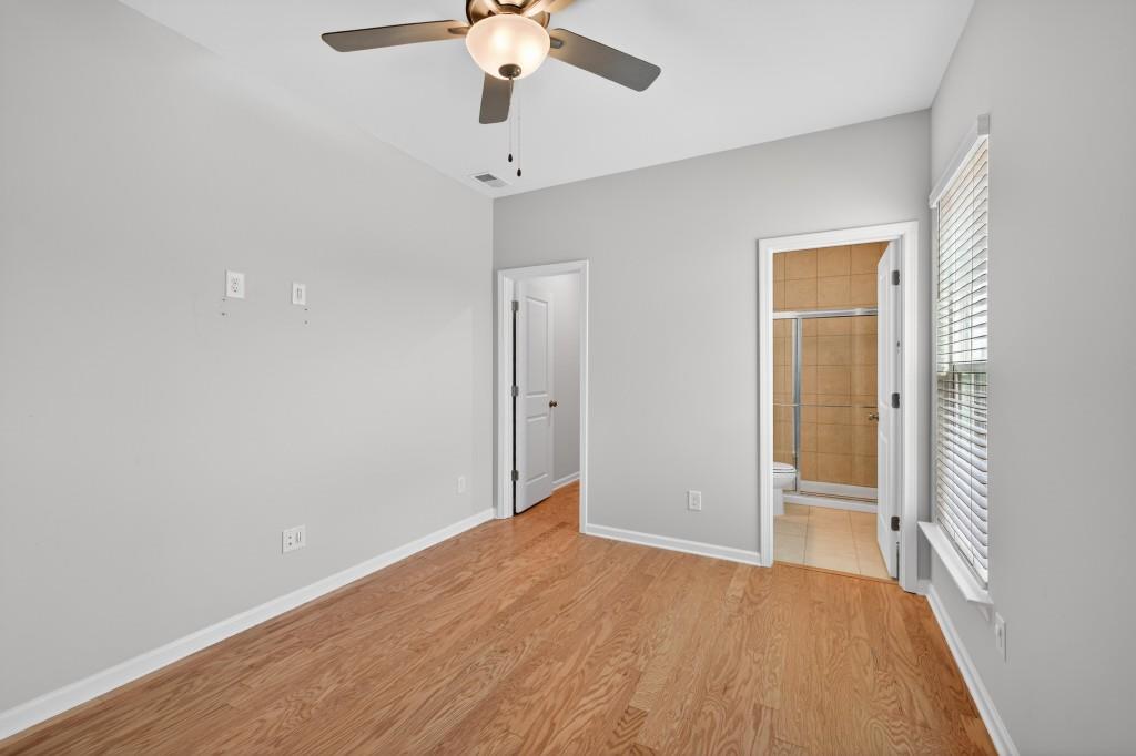 7277 Maple Brook Lane Flowery Branch, GA 30542 - Photo 30 of 57 wooden floor in an empty room with a window