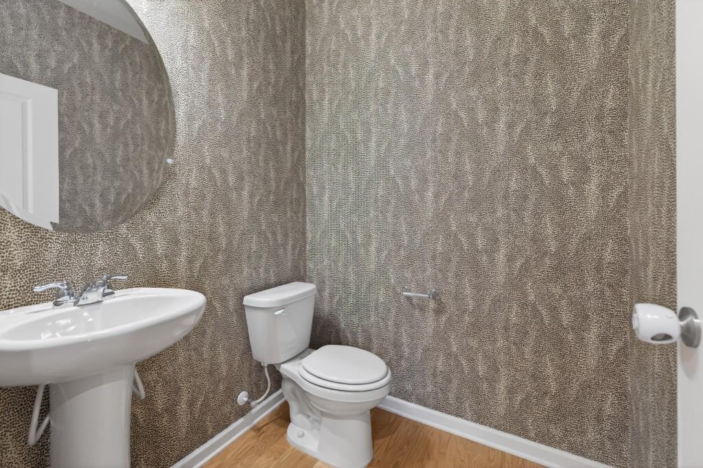 7277 Maple Brook Lane Flowery Branch, GA 30542 - Photo 31 of 57 a bathroom with a toilet a sink and a shower