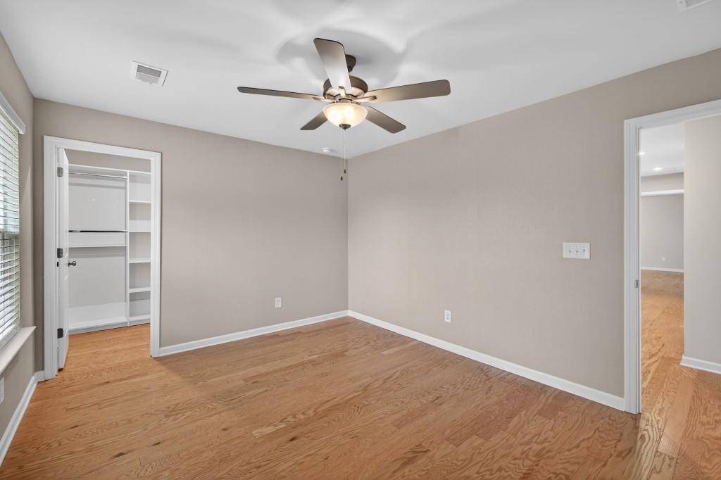 7277 Maple Brook Lane Flowery Branch, GA 30542 - Photo 39 of 57 an empty room with closet and a chandelier fan