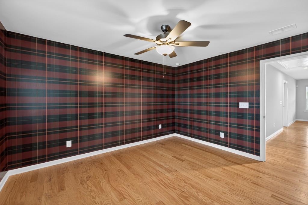 7277 Maple Brook Lane Flowery Branch, GA 30542 - Photo 41 of 57 a view of empty room with wooden floor and fan
