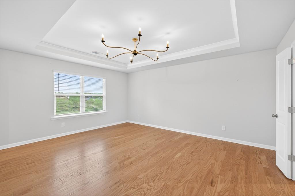 7277 Maple Brook Lane Flowery Branch, GA 30542 - Photo 46 of 57 wooden floor in an empty room with a window