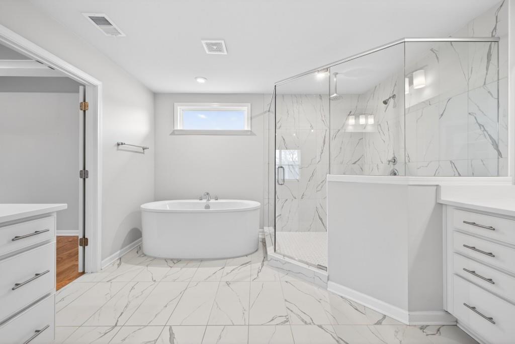 7277 Maple Brook Lane Flowery Branch, GA 30542 - Photo 52 of 57 a bathroom with a bathtub and a sink