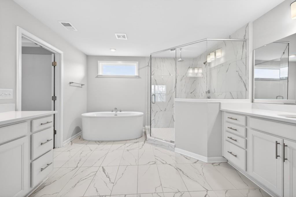 7277 Maple Brook Lane Flowery Branch, GA 30542 - Photo 53 of 57 a bathroom with a tub sink and mirror