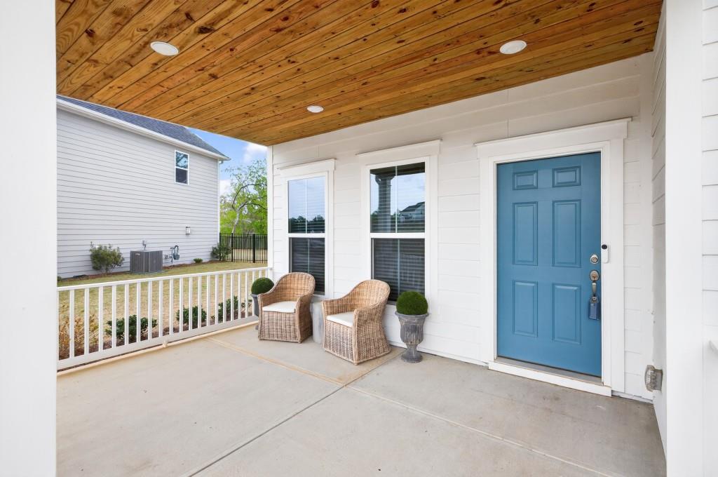 7277 Maple Brook Lane Flowery Branch, GA 30542 - Photo 7 of 57 a view of a balcony with furniture and floor to ceiling window