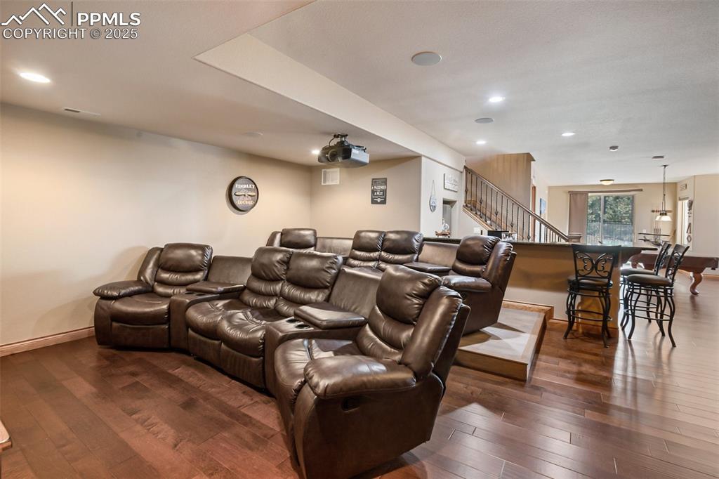 5070 Vessey Road Colorado Springs, CO 80908 - Photo 20 of 43 Cinema featuring recessed lighting, dark wood-style floors, and baseboards