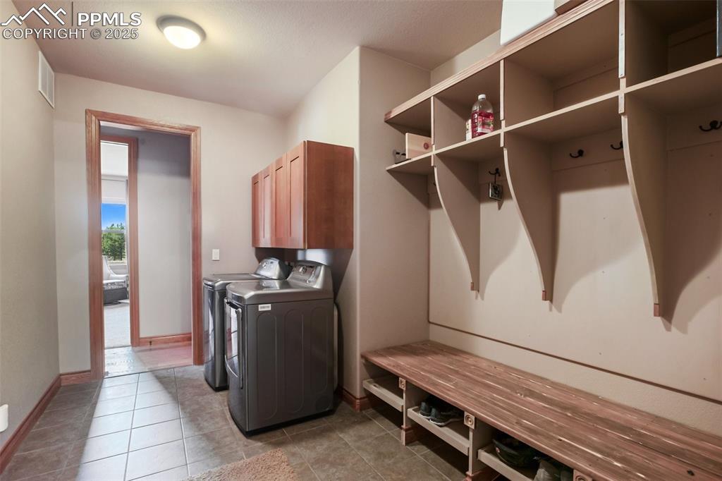 5070 Vessey Road Colorado Springs, CO 80908 - Photo 36 of 49 Clothes washing area featuring visible vents, washer and dryer, cabinet space, light tile patterned floors, and baseboards
