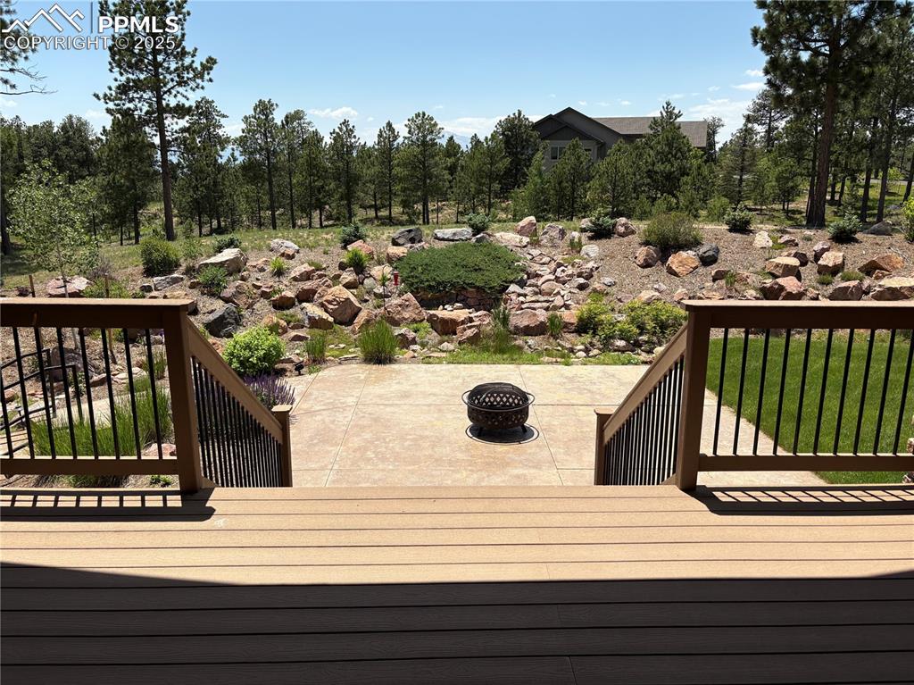 5070 Vessey Road Colorado Springs, CO 80908 - Photo 7 of 43 Wooden terrace with a fire pit and a patio