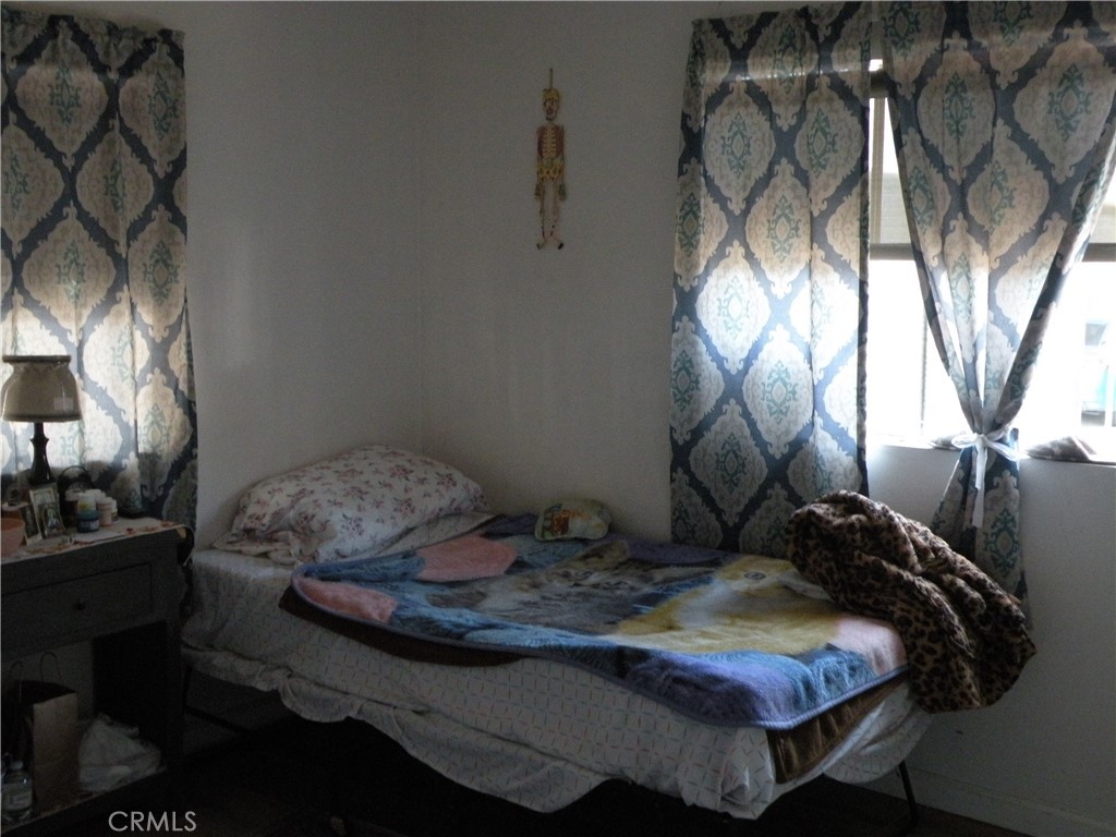 350 East San Jacinto Avenue, Unit 121 Perris, CA 92571 - Photo 13 of 24 a bedroom with a bed and a chandelier
