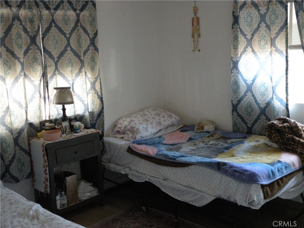 350 East San Jacinto Avenue, Unit 121 Perris, CA 92571 - Photo 14 of 24 a room with a bed and a mirror