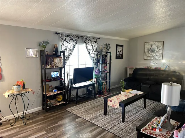 a living room with furniture a bookshelf and a window