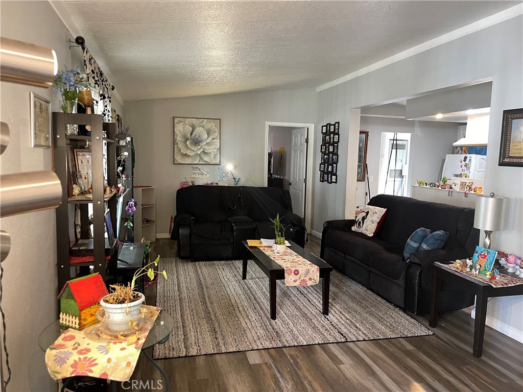350 East San Jacinto Avenue, Unit 121 Perris, CA 92571 - Photo 17 of 24 a living room with furniture and wooden floor