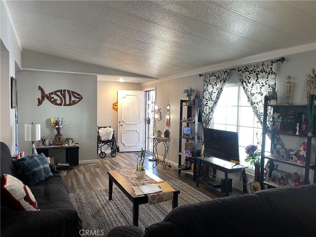 350 East San Jacinto Avenue, Unit 121 Perris, CA 92571 - Photo 18 of 24 a living room with furniture a flat screen tv and a large window