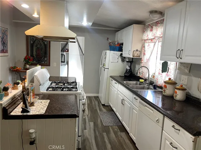 a kitchen with sink refrigerator and stove