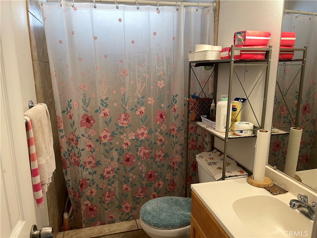 350 East San Jacinto Avenue, Unit 121 Perris, CA 92571 - Photo 21 of 24 a bathroom with a sink toilet and shower