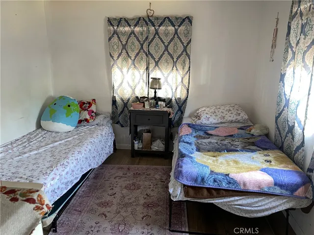 a bed sitting in a bedroom next to a window