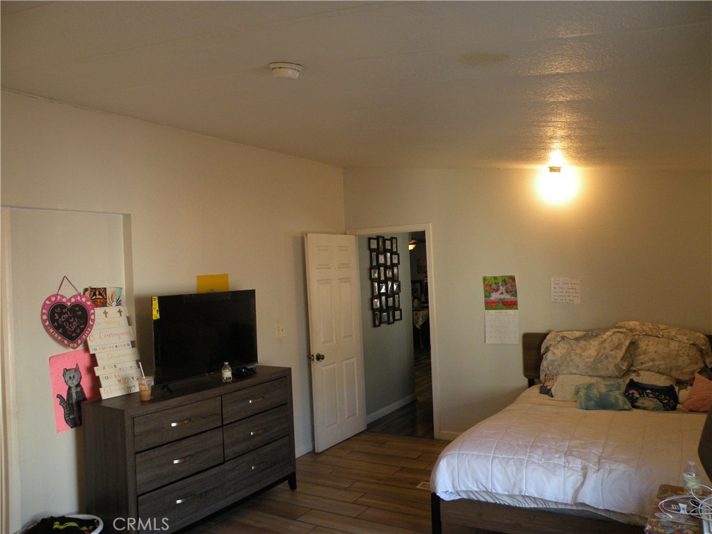 350 East San Jacinto Avenue, Unit 121 Perris, CA 92571 - Photo 7 of 24 a bedroom with a bed and flat screen tv