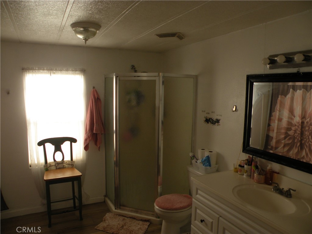 350 East San Jacinto Avenue, Unit 121 Perris, CA 92571 - Photo 8 of 24 a bathroom with a sink toilet and shower