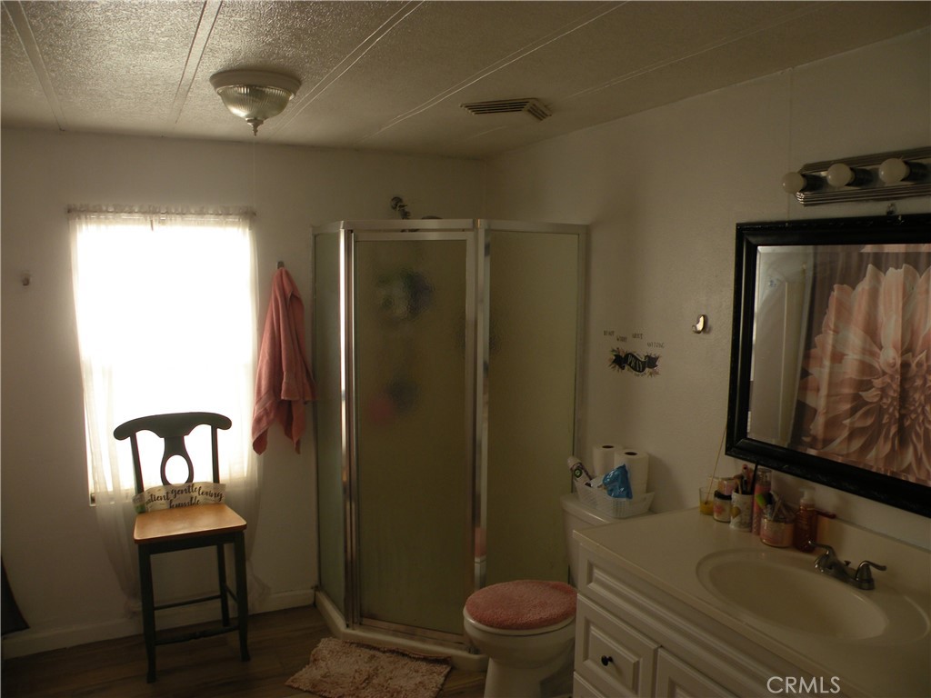 350 East San Jacinto Avenue, Unit 121 Perris, CA 92571 - Photo 9 of 24 a bathroom with a sink toilet and shower