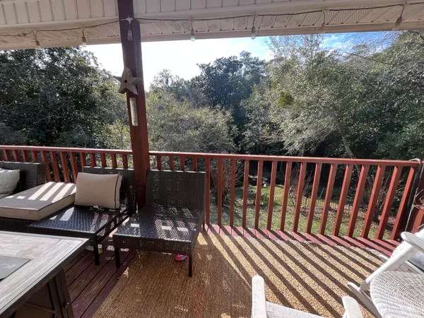 a view of a two chairs and table in the balcony