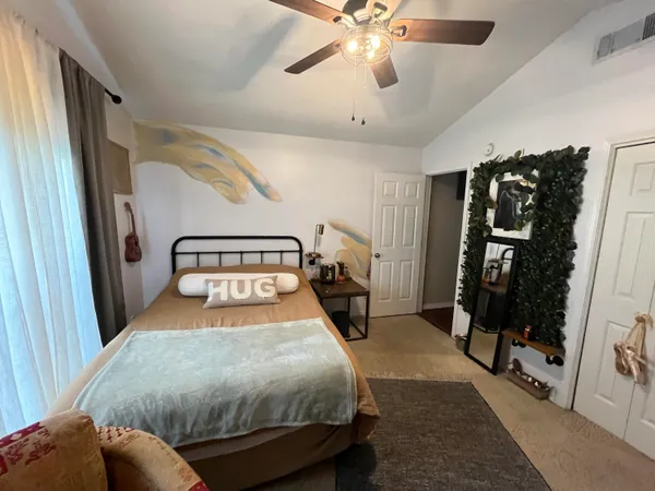 a bedroom with a bed and a window