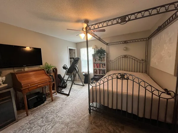 a bedroom with a bed and a chandelier