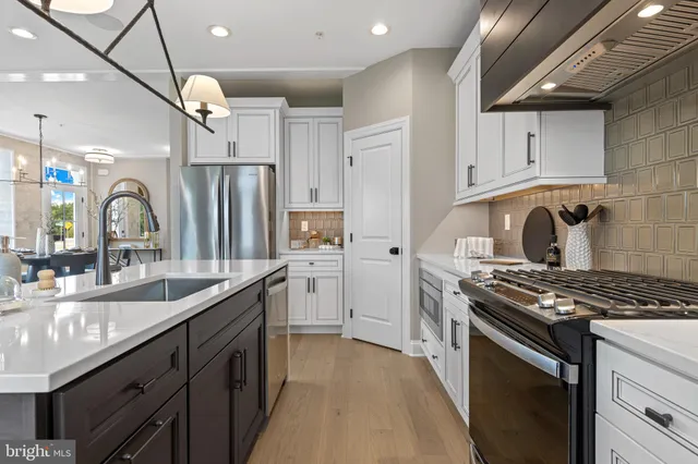 a kitchen with granite countertop a sink stove and cabinets