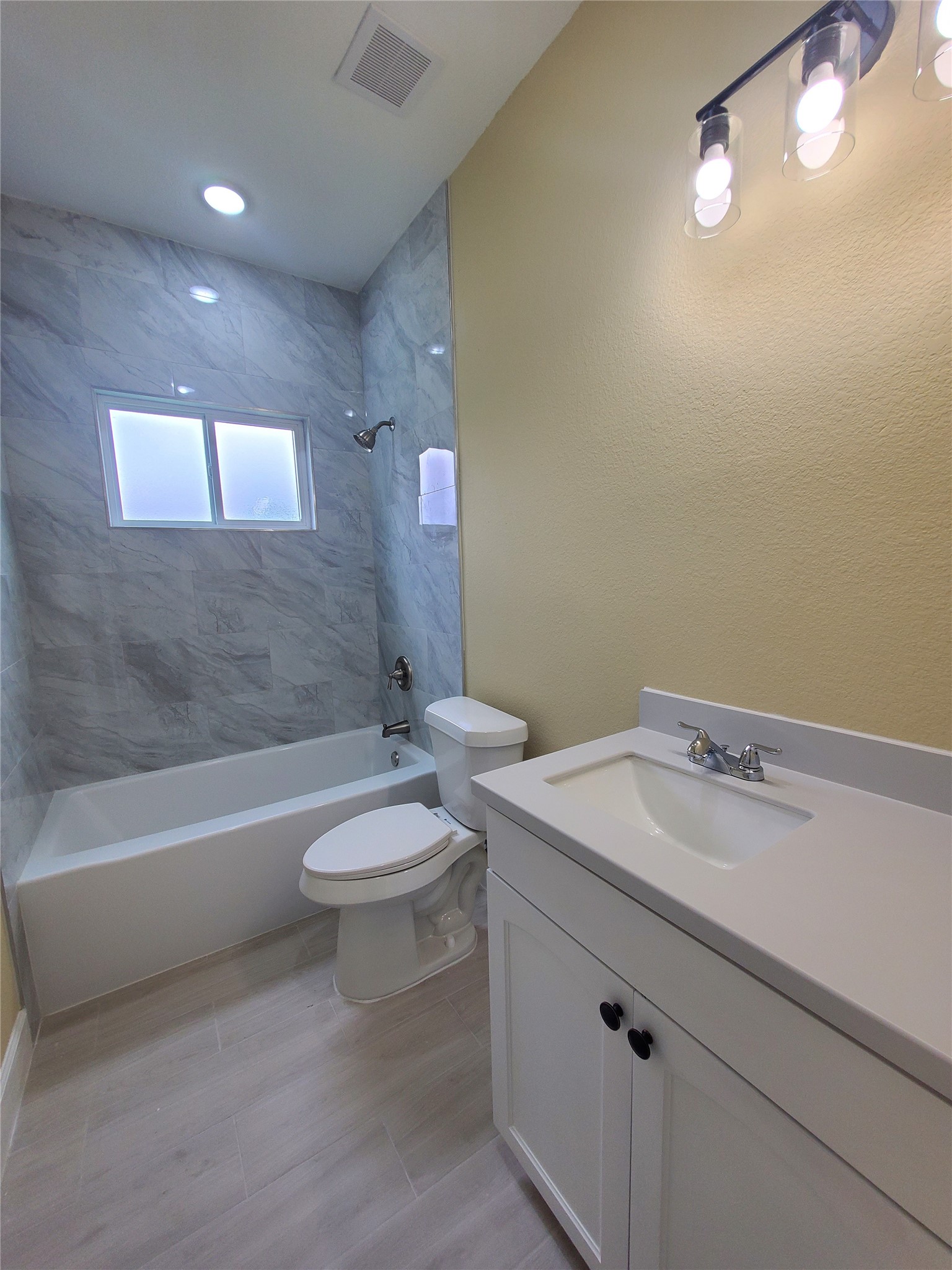1306 North 9th Street Conroe, TX 77301 - Photo 22 of 47 a bathroom with a sink a toilet and bathtub