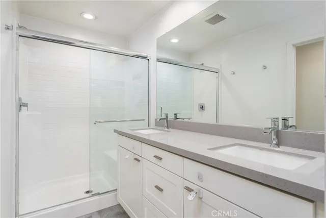 a bathroom with a granite countertop sink mirror and double