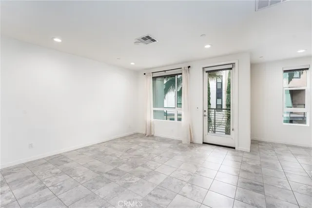 a view of an empty room with glass door