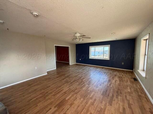 822 East Santa Fe Avenue Canadian, TX 79014 - Photo 12 of 19 wooden floor in an empty room with a window