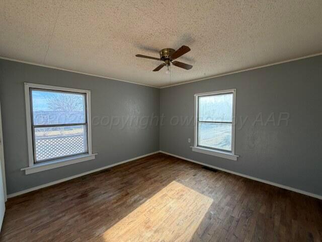 822 East Santa Fe Avenue Canadian, TX 79014 - Photo 14 of 19 a view of empty room with wooden floor and fan
