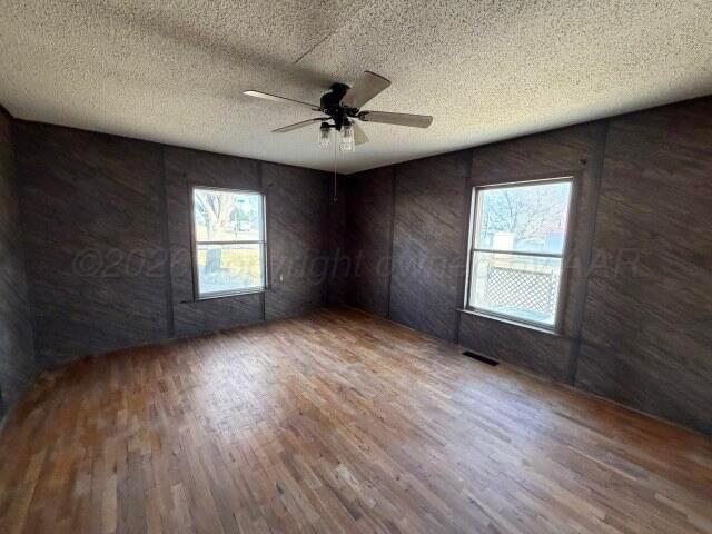 822 East Santa Fe Avenue Canadian, TX 79014 - Photo 16 of 19 an empty room with windows and ceiling fan