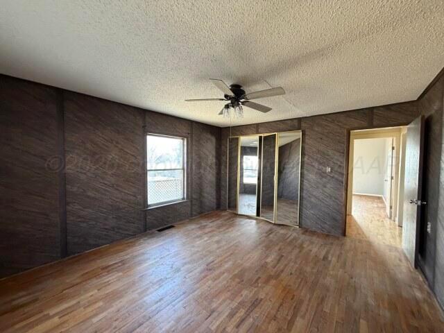 822 East Santa Fe Avenue Canadian, TX 79014 - Photo 17 of 19 a view of an empty room with wooden floor and a window