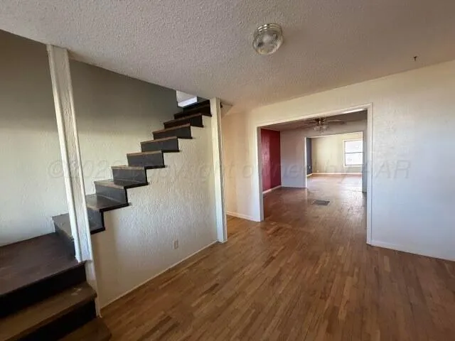 wooden floor in an empty room with a gallery