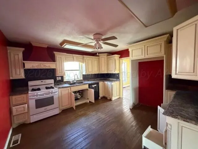 a kitchen with stainless steel appliances granite countertop a stove a sink dishwasher a microwave oven and a refrigerator with wooden floor