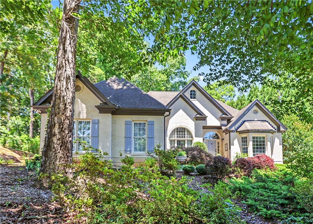 537 Old Collins Road Hoschton, GA 30548 - Photo 1 of 42 a front view of a house with a yard and trees