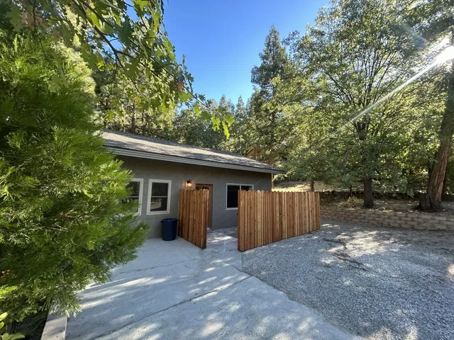 a view of a house with a backyard and garage