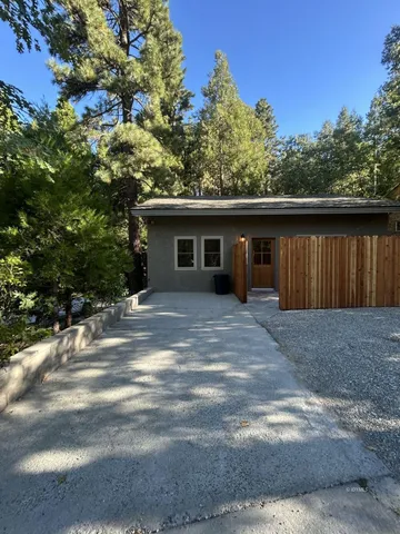 a view of house with outdoor space and garden