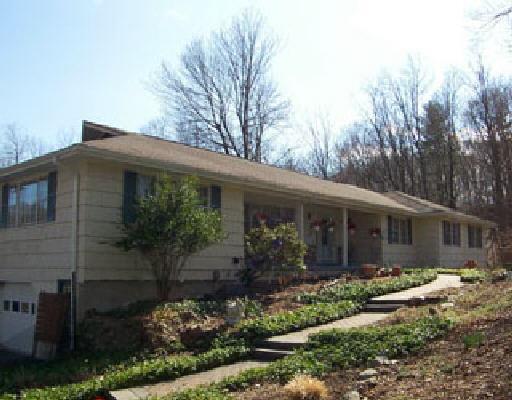 51 Marshall Road Ridgefield, CT 06877 - Photo 1 of 1 a front view of house with a garden