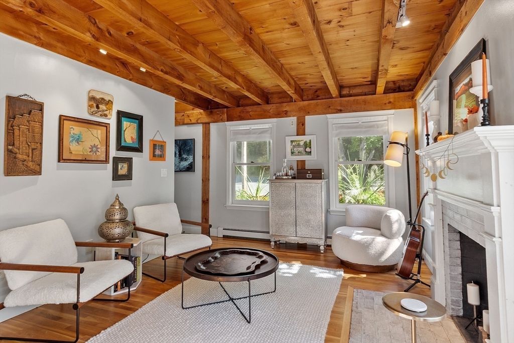 55 Carroll Road Grafton, MA 01536 - Photo 14 of 40 a living room with furniture a fireplace and a table