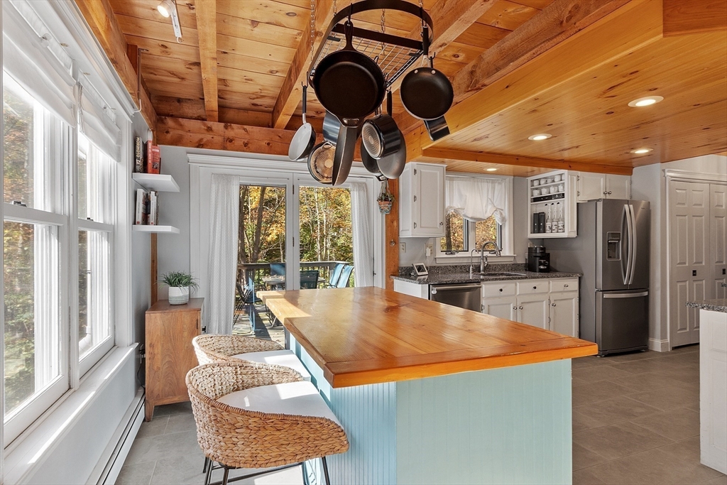 55 Carroll Road Grafton, MA 01536 - Photo 18 of 40 a room with stainless steel appliances kitchen island granite countertop furniture and a large window
