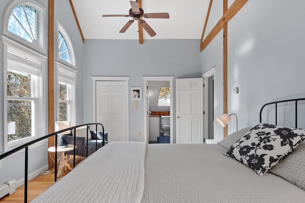 55 Carroll Road Grafton, MA 01536 - Photo 22 of 40 a bedroom with a bed and a chandelier