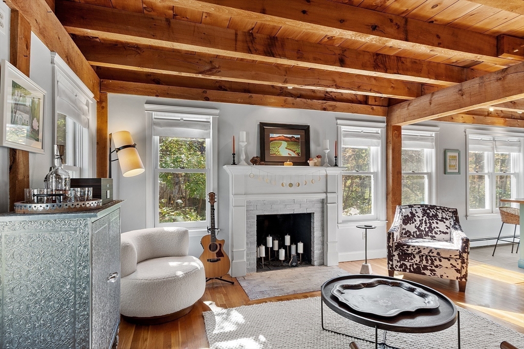 55 Carroll Road Grafton, MA 01536 - Photo 4 of 40 a living room with furniture a fireplace and a table