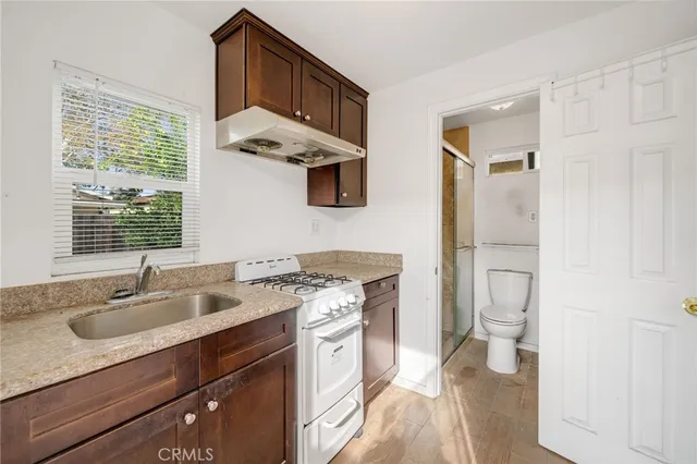 a bathroom with a toilet a sink and shower