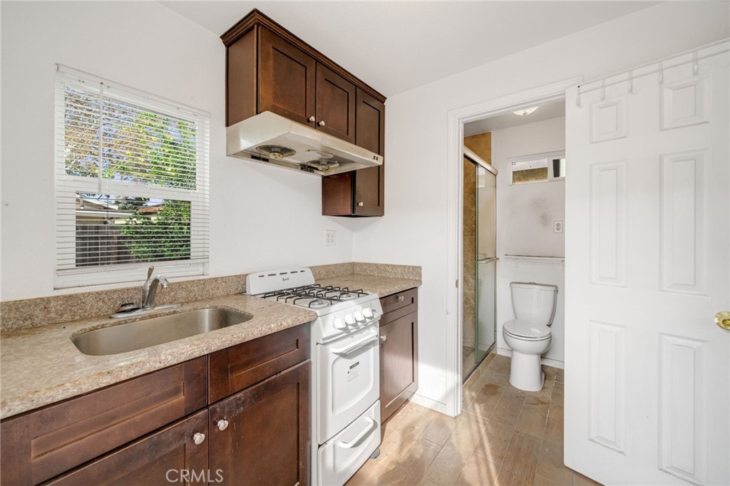 13223 3rd Street Chino, CA 91710 - Photo 12 of 15 a kitchen with a sink stove and refrigerator