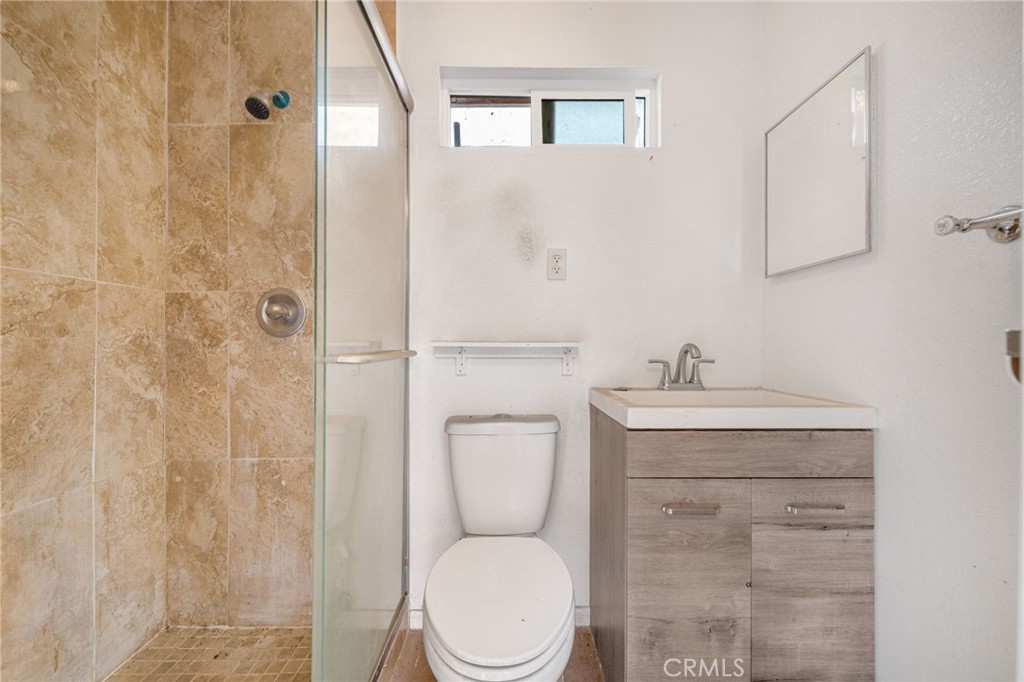 13223 3rd Street Chino, CA 91710 - Photo 13 of 15 a bathroom with a toilet a sink and shower