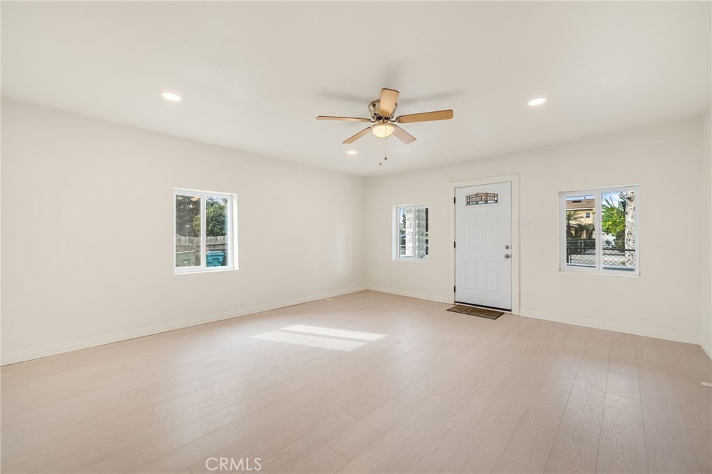 13223 3rd Street Chino, CA 91710 - Photo 3 of 15 an empty room with windows and ceiling fan